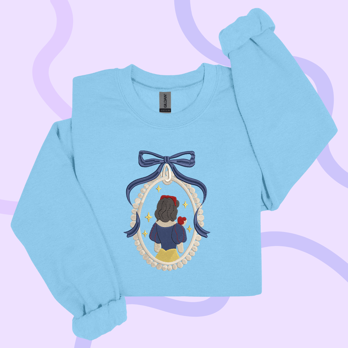 A light blue long-sleeved shirt with a blue ribbon and a framed image of a woman with a bow on her head.