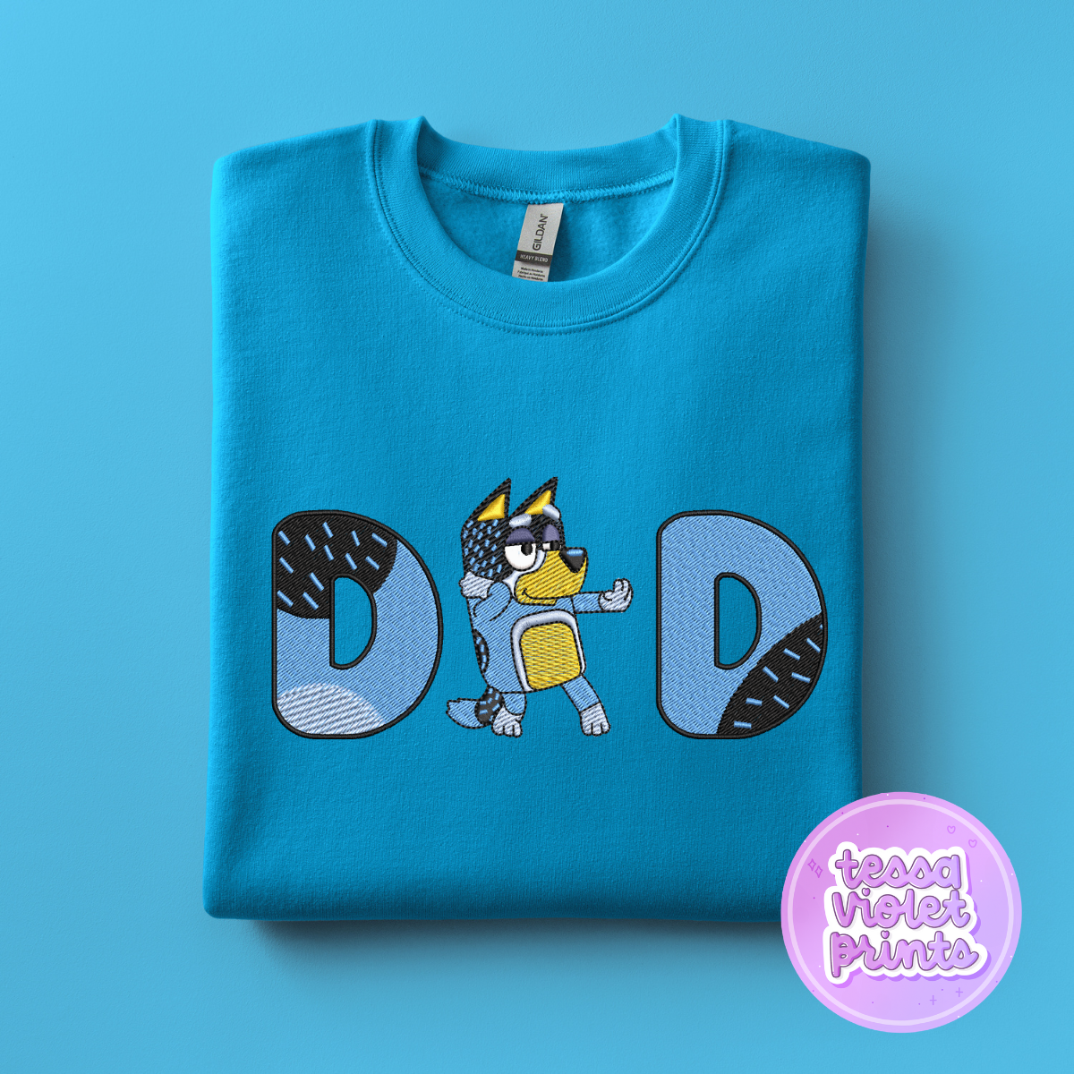 A blue t-shirt with a cartoon character and the word "DAD" printed on it.