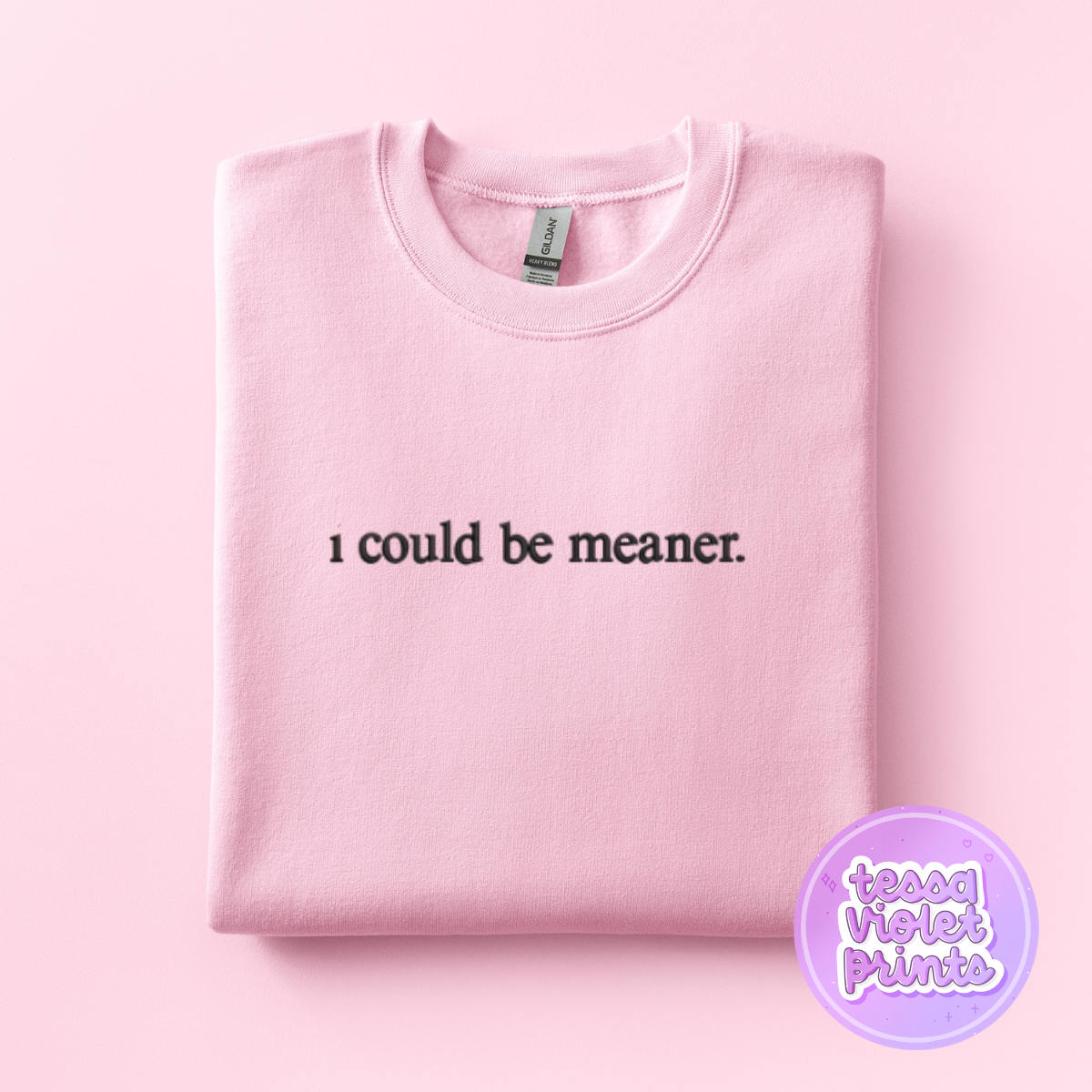A pink sweatshirt with the text "I could be meaner" printed on it.
