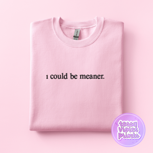 A pink sweatshirt with the text "I could be meaner" printed on it.