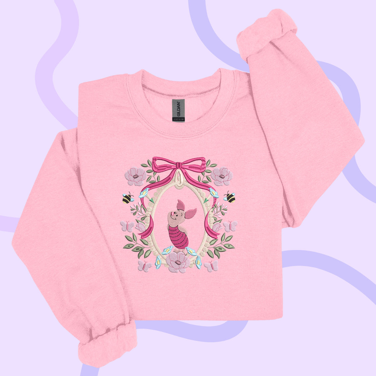 A pink long-sleeved shirt with a floral design and a pig character on it.