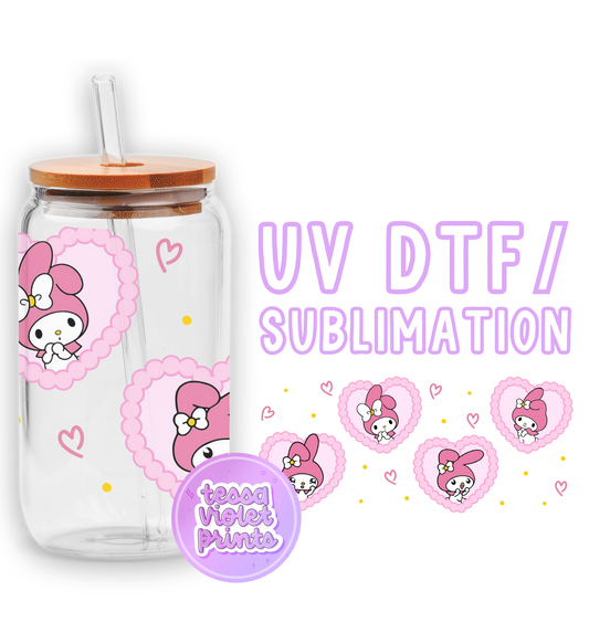 a glass cup with a hello kitty sticker on it