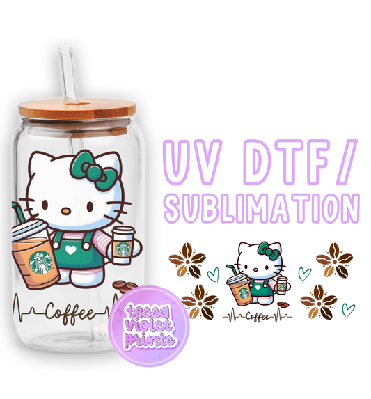 a glass cup with a hello kitty design on it