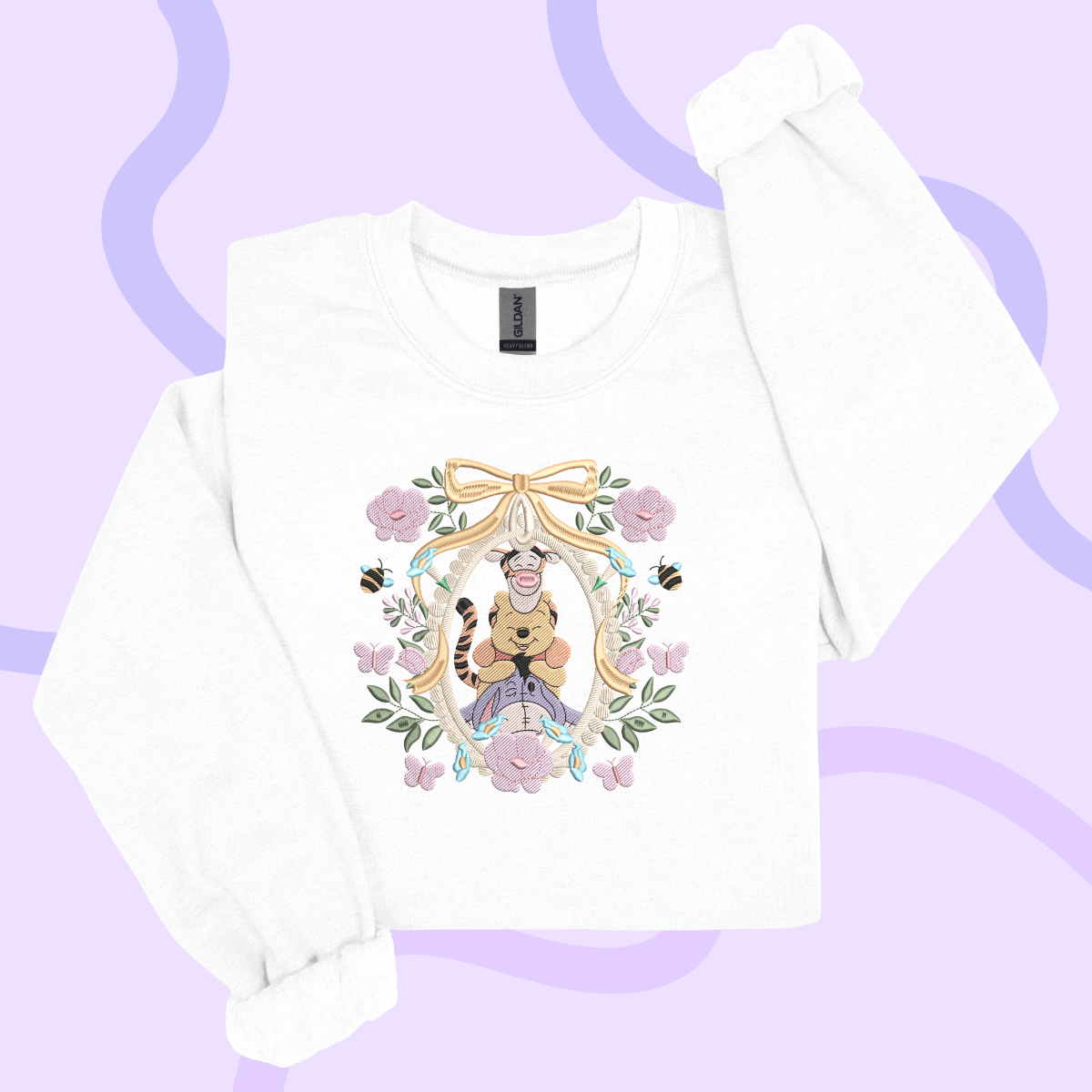 A white long-sleeved shirt with a colorful graphic design featuring a cartoon character surrounded by flowers and butterflies.