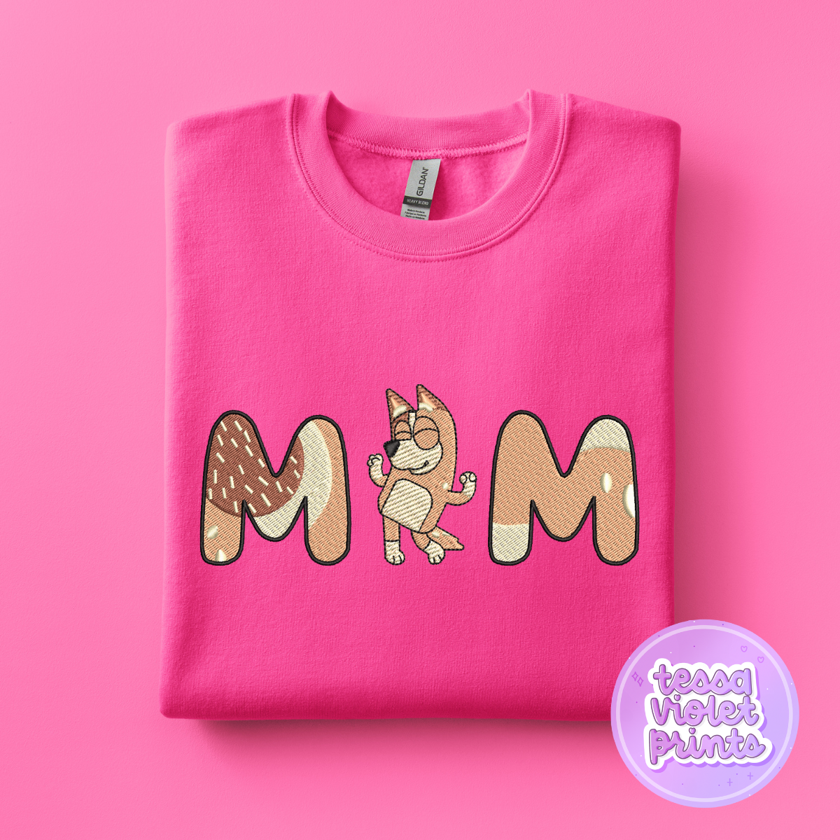 A pink sweatshirt with the word "MOM" printed on it, featuring a cartoon character.