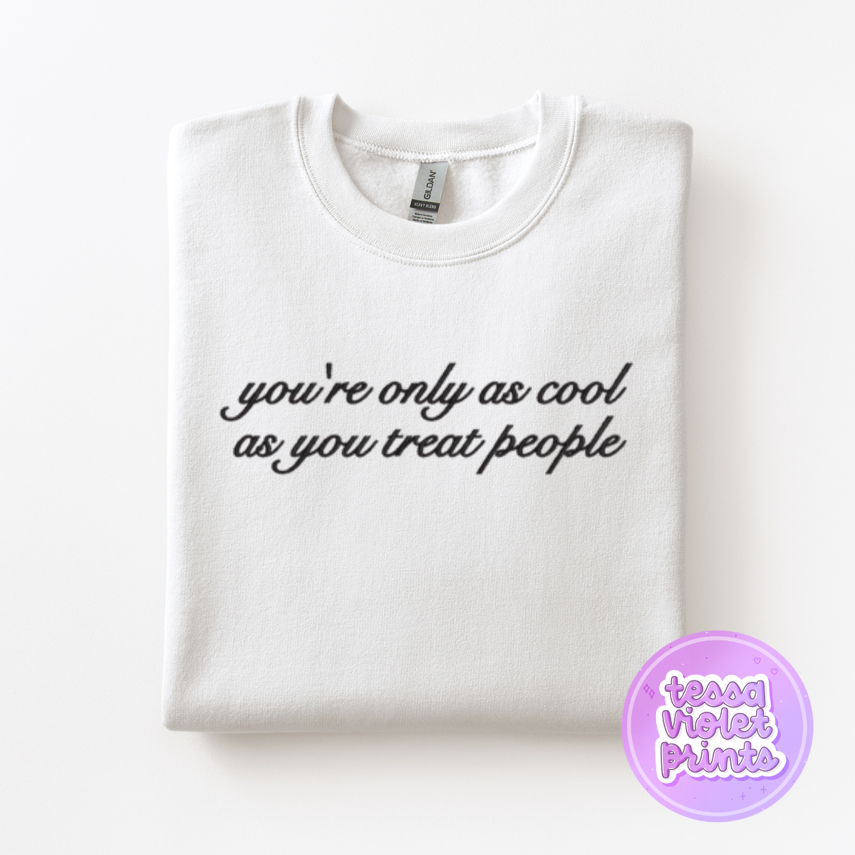 A white t-shirt with the text "you're only as cool as you treat people" printed on it.