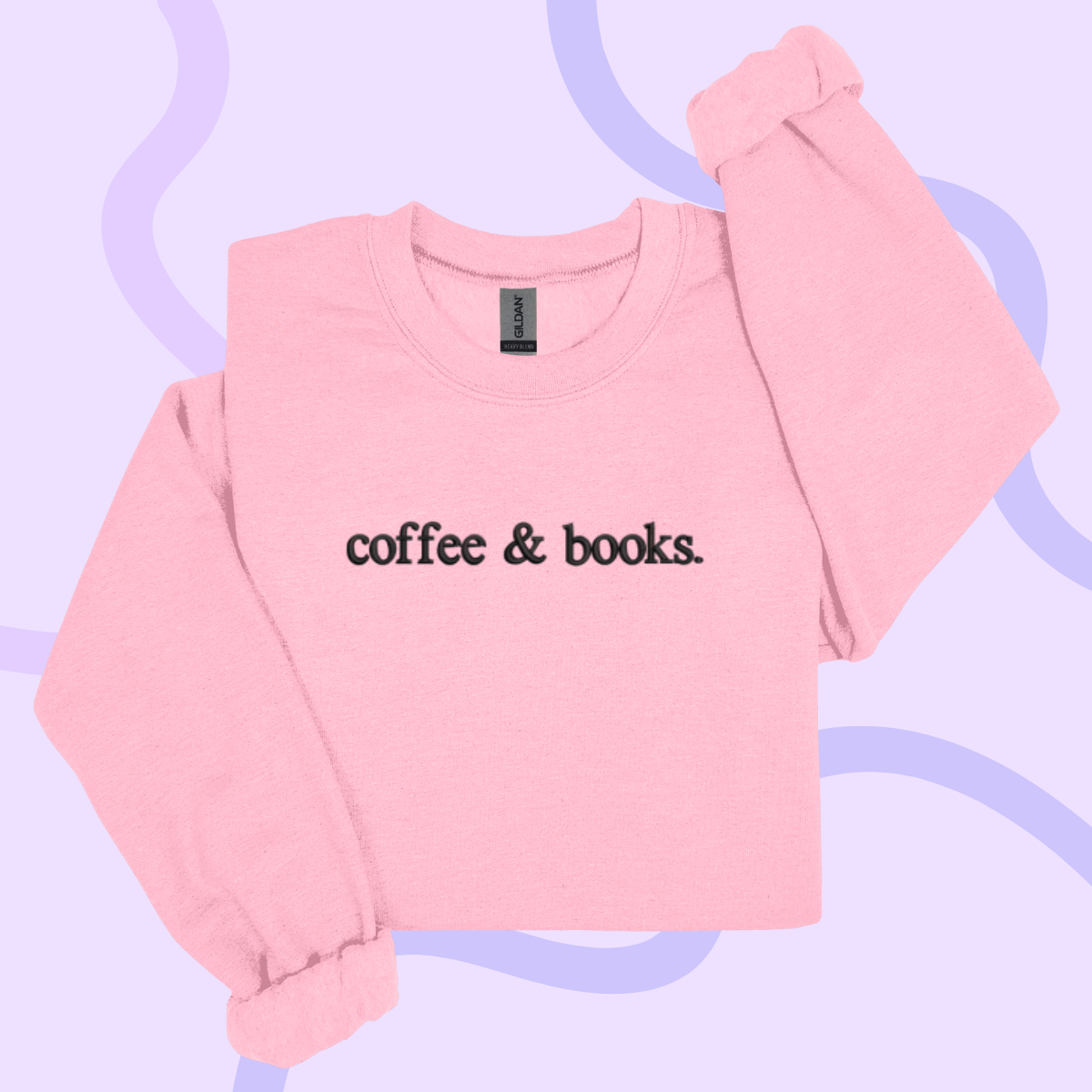 A pink sweatshirt with the text "coffee & books" printed on it.
