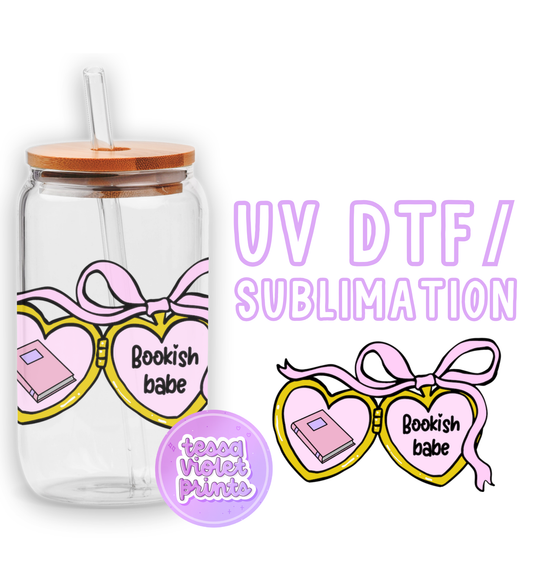 a glass jar with a pink ribbon and a pair of sunglasses